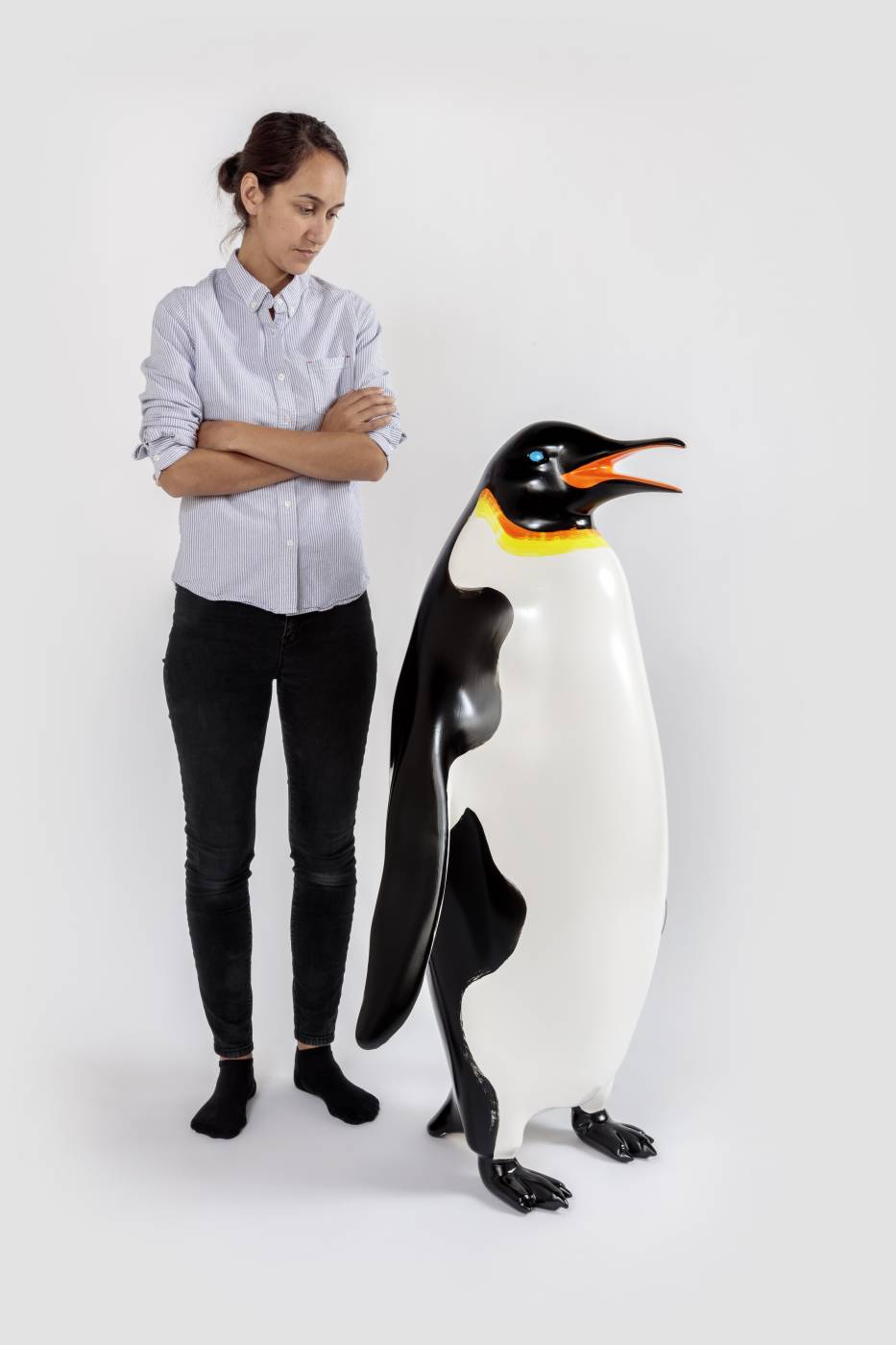 Penguin sculpture next to human