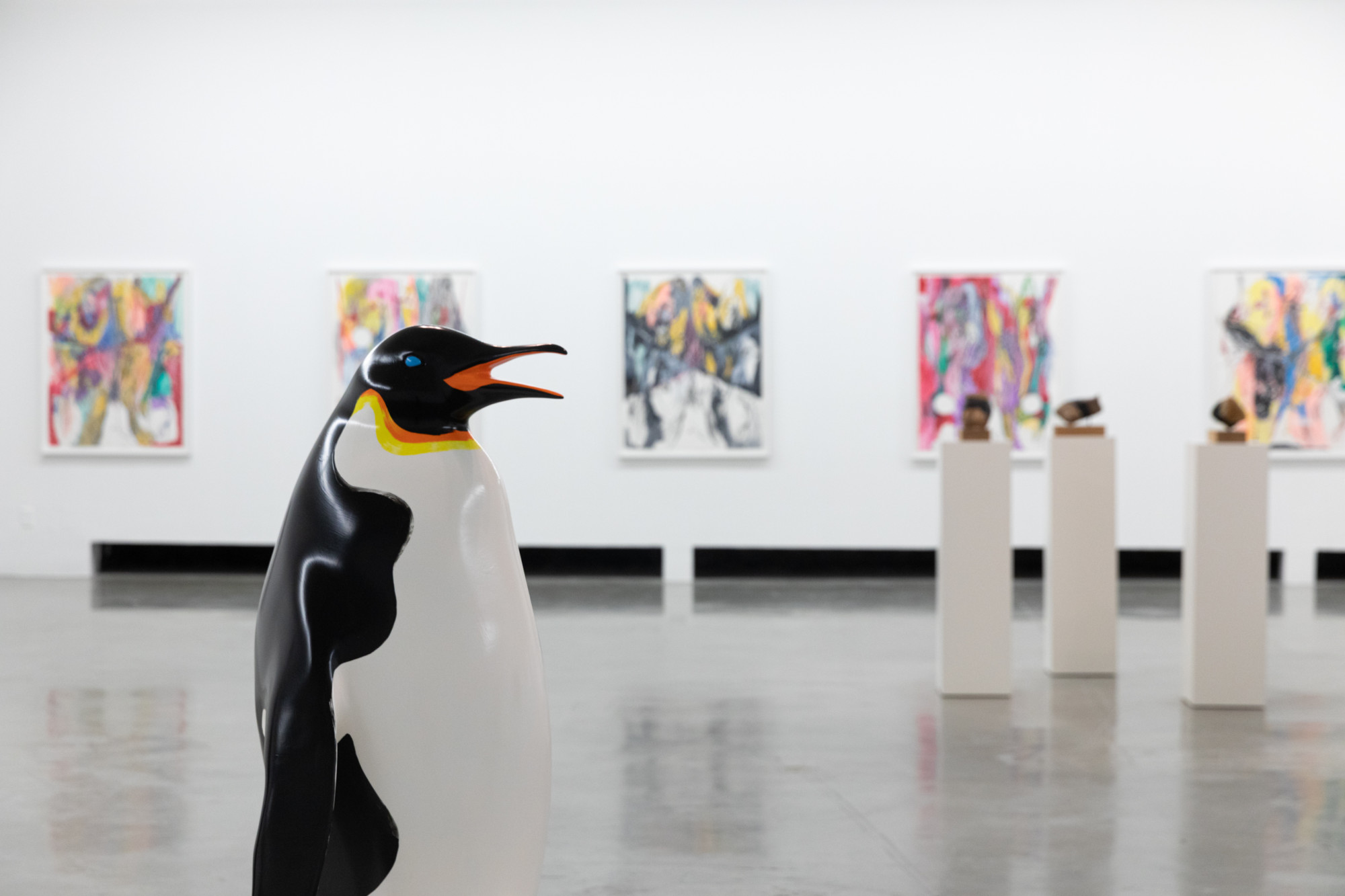 Artworks in gallery, penguin sculptures in front